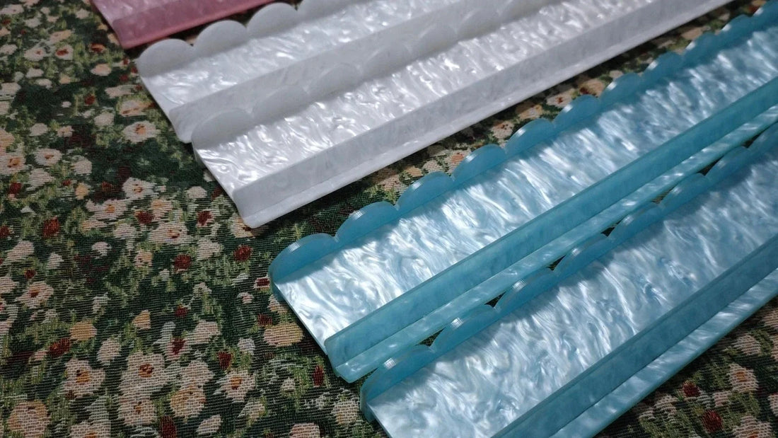 Pink, blue and white pearlescent mahjong racks and matching pushers displayed together.