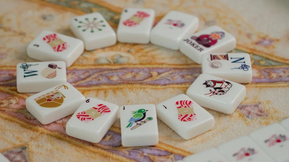 Cat-themed Cozy Nest mahjong tiles arranged on a patterned mat for a game-night gift.