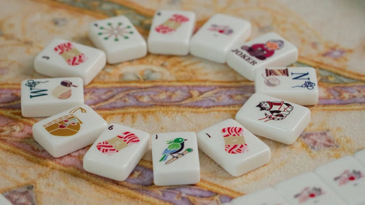 Cat-themed Cozy Nest mahjong tiles arranged on a patterned mat for a game-night gift.