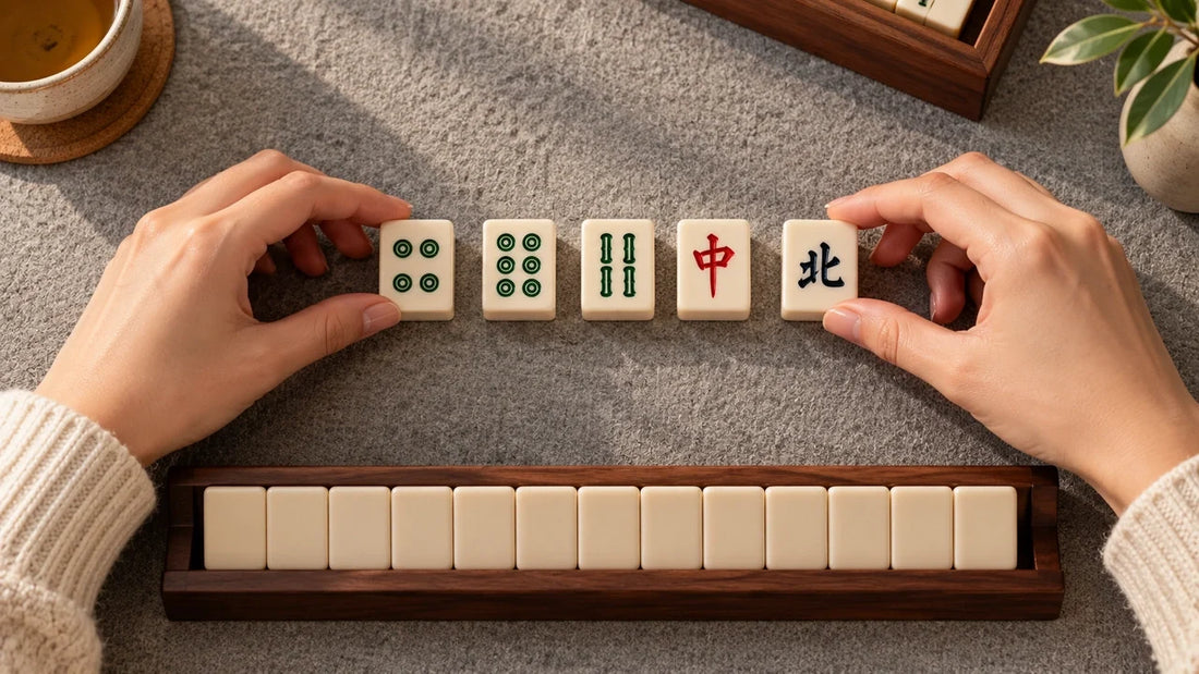 Overhead view of a practice rack and separated dot, bamboo, dragon and wind tiles on gray felt.