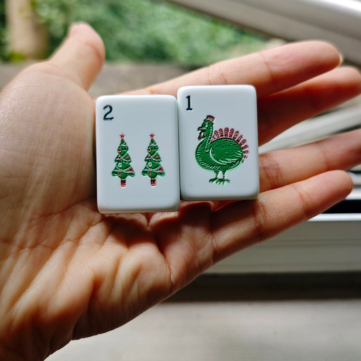 Detail view of holiday tile backs and layered acrylic construction in the BamChive Christmas Magic American Mahjong set