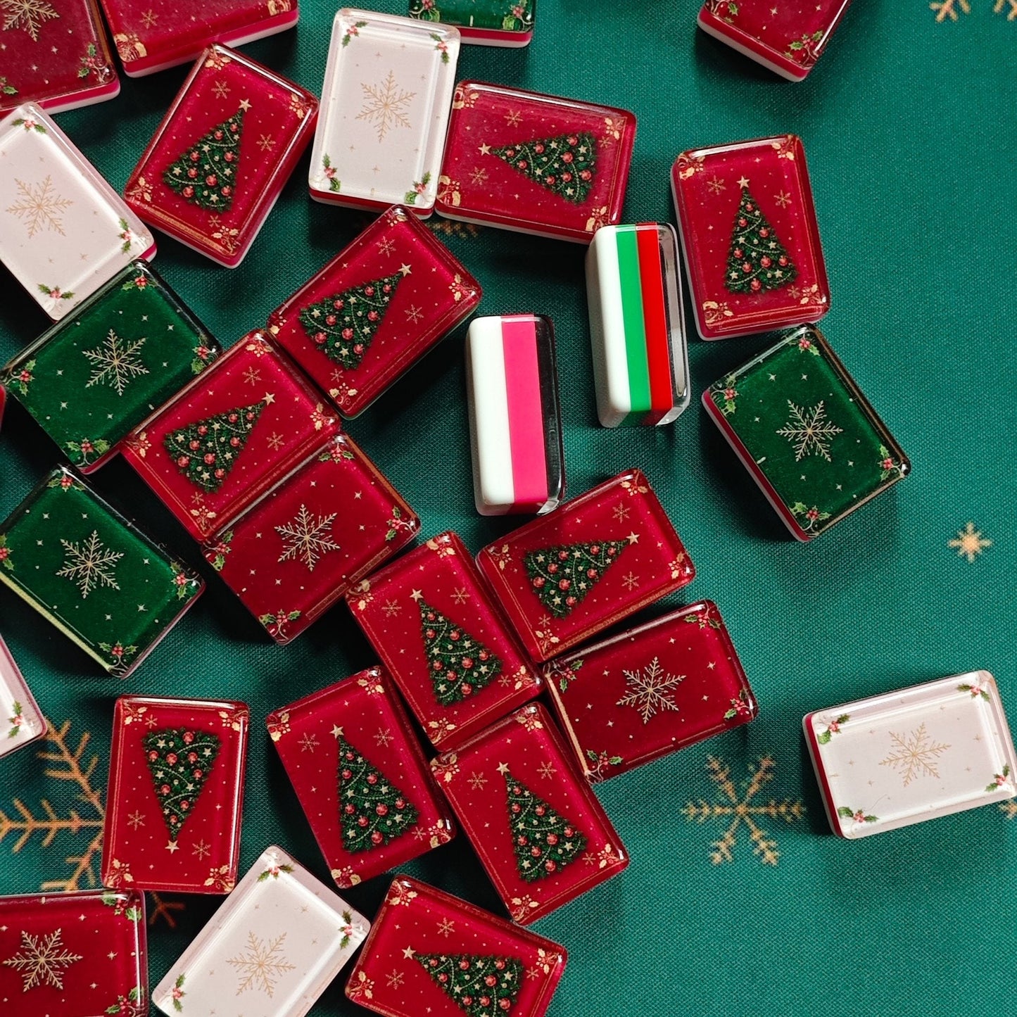 Layered acrylic sides of BamChive Christmas Magic American Mahjong tiles in red, green, cream, and white