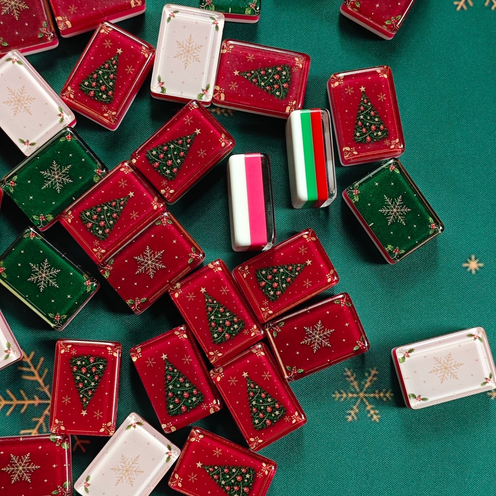 Layered acrylic sides of BamChive Christmas Magic American Mahjong tiles in red, green, cream, and white