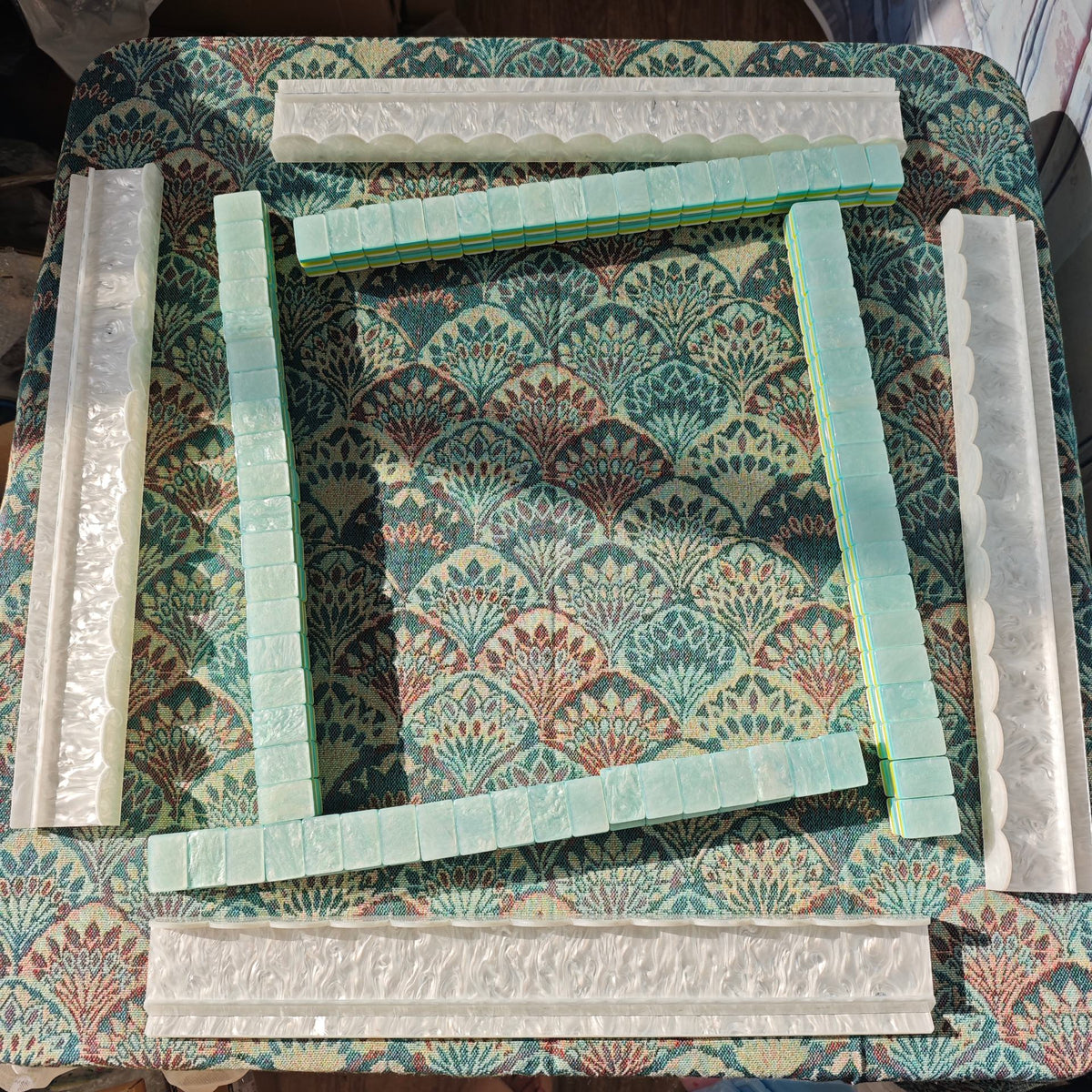 Four BamChive pearlescent magnetic acrylic mahjong racks and pushers arranged for American Mahjong play with display tiles