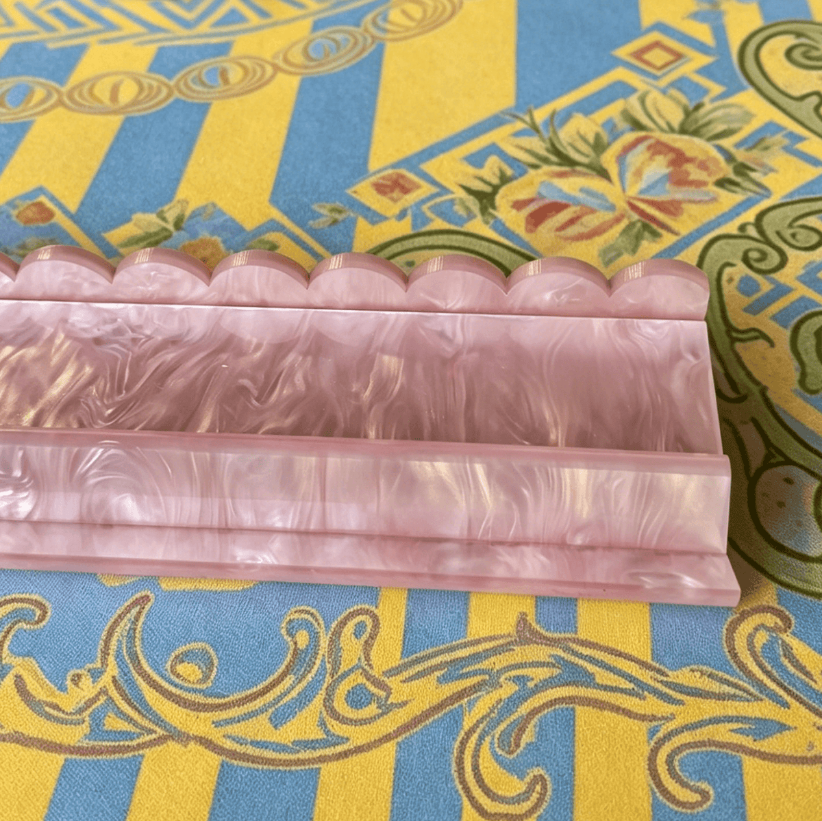 Close-up of a Pink BamChive pearlescent magnetic acrylic mahjong rack and pusher
