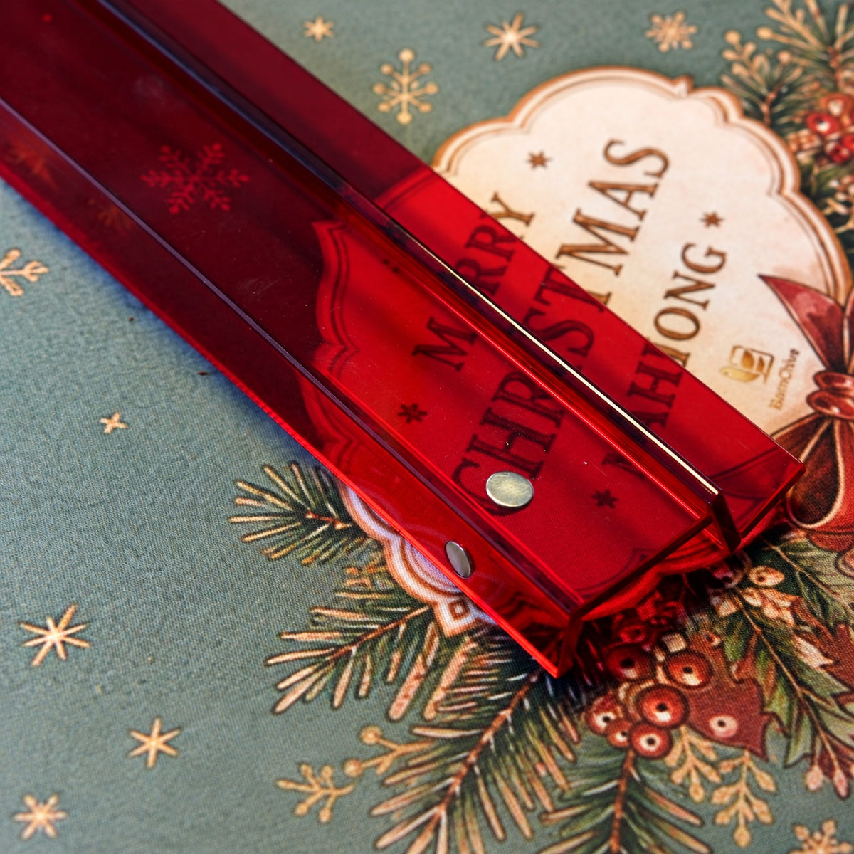 Detail of the red acrylic mahjong rack and pusher showing the magnetic connection and angled tile support.